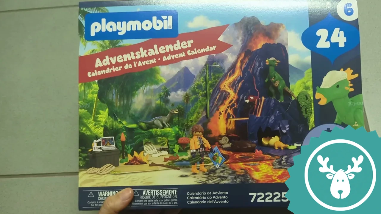 Auf der Vorderseite des Adventskalenders ist die spannende Dino-Expedition mit Vulkan und Urwald abgebildet.