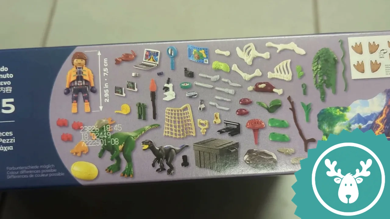 Die Seitenansicht zeigt den Inhalt: zwei Dinos, eine Forscherfigur, Fossilien und jede Menge Expeditionszubehör.